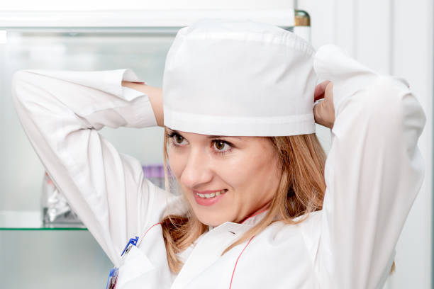 istock Doctor puts on medical cap. 1216776160