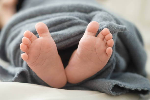 istock baby's feet in a blanket 1216777292