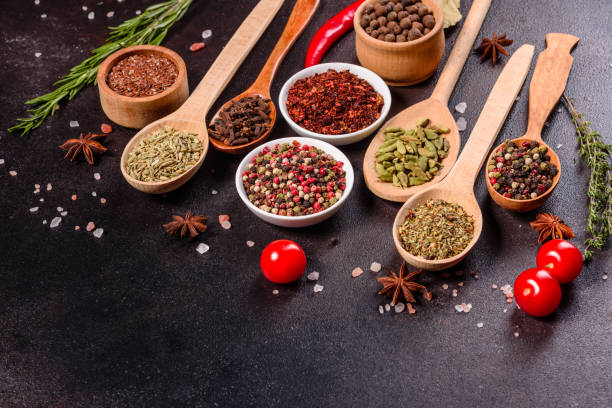 istock Pepper, salt, paprika, basil and other on a dark background 1216777817