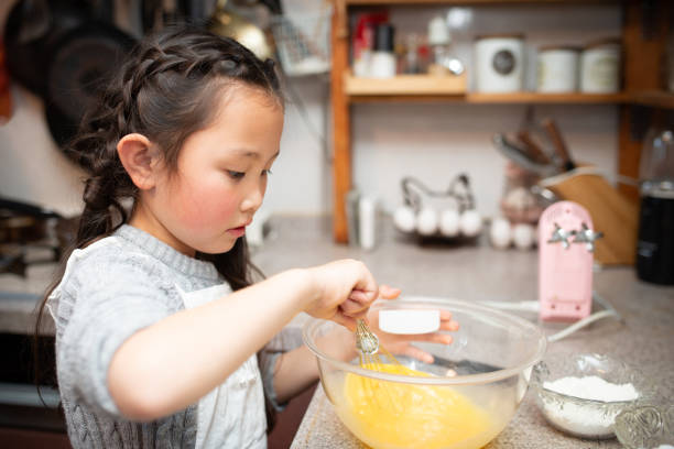 istock Girl making cake at home 1216777897