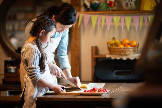 Mother and daughter making cake at home