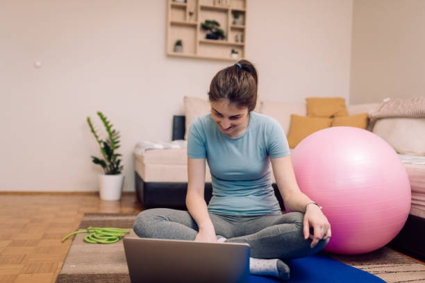 istock Young woman searching for  online yoga tutorials 1216778291