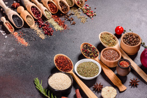 istock Pepper, salt, paprika, basil and other on a dark background 1216779086