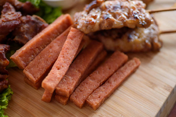 Grilled chicken sausages ready to eat on a plate on a wooden table