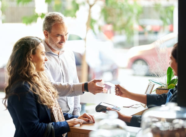 doing cashless payment - couple restaurant day south america imagens e fotografias de stock