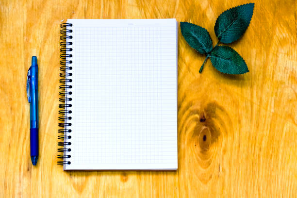 istock Cup of coffe and open notebook on wooden background 1216784146