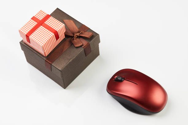 istock Online shopping concept with gift box and computer mouse isolated on white 1216785509