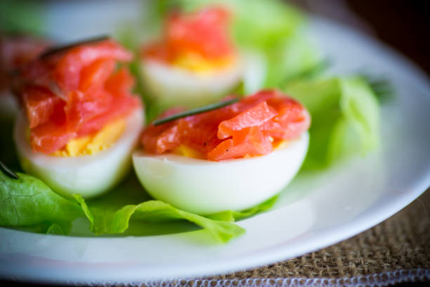 istock boiled eggs with salted red fish and salad leaves 1216785614