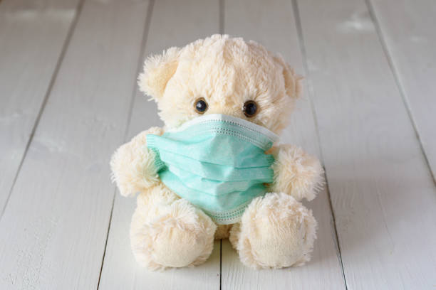 istock Children's teddy bear in a medical mask 1216785645