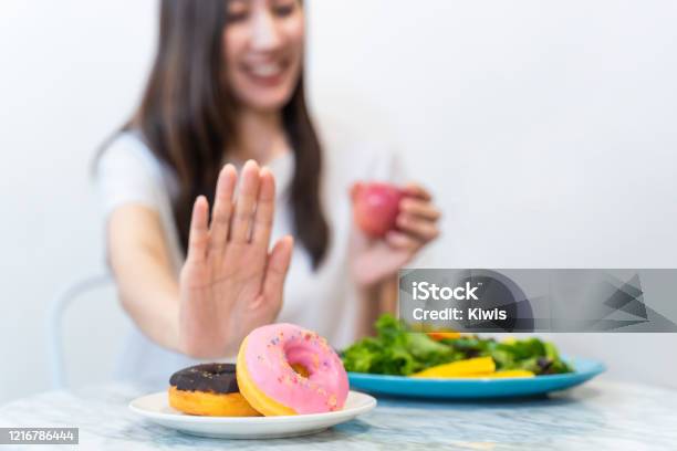 Asian Young Woman Refuse Junk Food While Choose To Eat Healthy Salad And Fruit Juice For Her Healthy Girl Take Care Of Herself By Having High Nutrition Food Every Day Good Food For Healthy Concept Stock Photo - Download Image Now