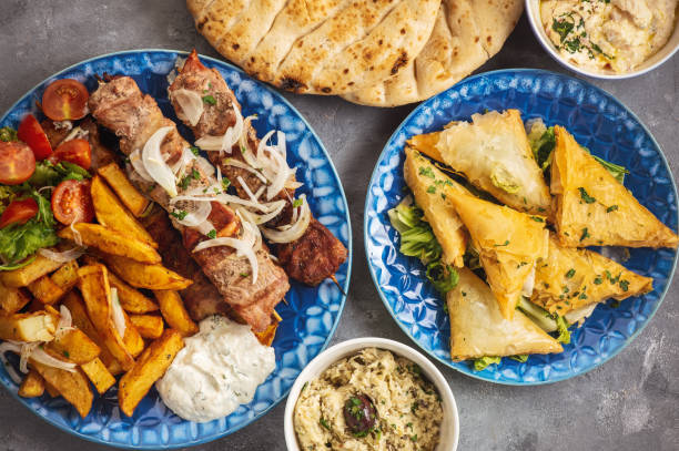 Souvlaki served with fried potatoes, tzatziki dip and pita bread, greek cuisine. Souvlaki served with fried potatoes, tzatziki dip and pita bread, greek cuisine greek food stock pictures, royalty-free photos & images
