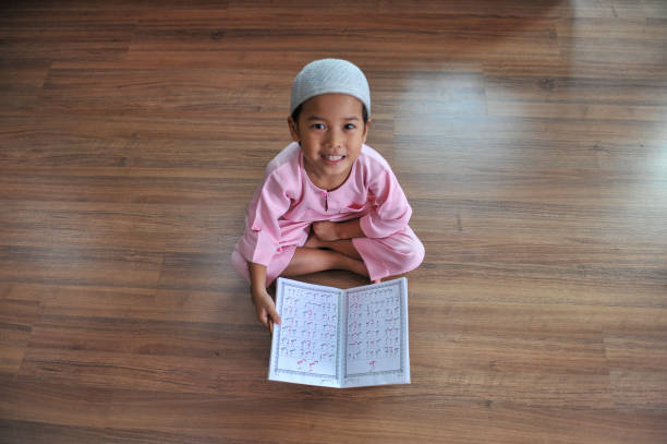 Portrait Of Smiling Boy With Quran