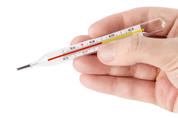 istock Hand holding thermometer showing high temperature on white 1216787944