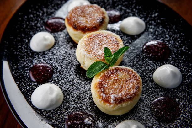istock Cheese pancake, cheesecakes with sour cream, jam, and mint on a plate. Morning breakfast. 1216788457