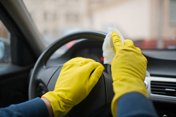 Man disinfecting vehicle interior