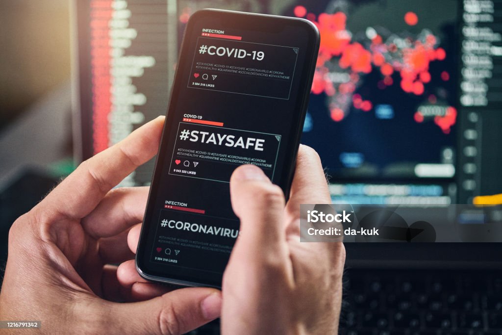 Using #satysafe hashtag for social networking Using #staysafe hashtag for social networking on a smart phone. A hashtag encouraging people to stay home and not risk health due to COVID-19 coronavirus disease. Defocused map with COVID-19 infected countries on the background Coronavirus Stock Photo