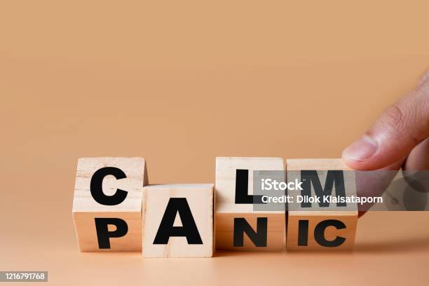 Hand Flipping Wooden Cubes For Change Wording Panic To Calm Mindset Is Important For Human Development Stock Photo - Download Image Now