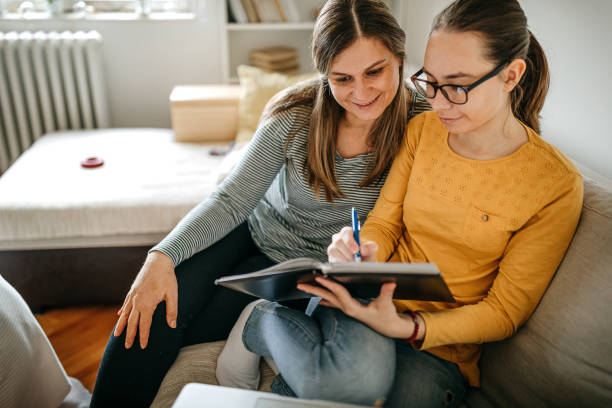 Mother helping daughter with homework