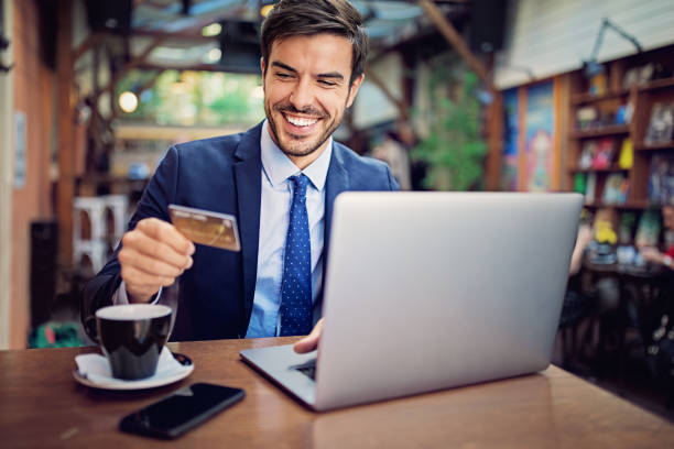 istock Businessman is shopping online/making reservation in a cafe 1216794900