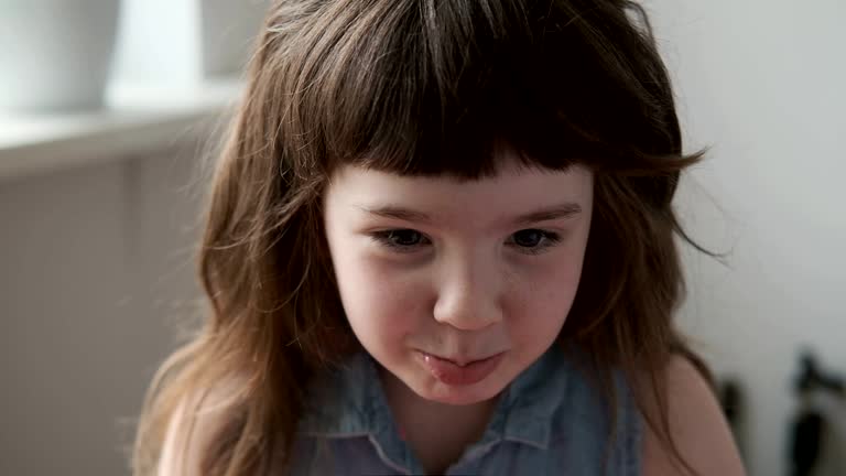 A 6-7 year old girl takes offense, pouting and doesn't agree