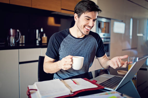 istock Man is working at home and video conferencing using his laptop 1216798260