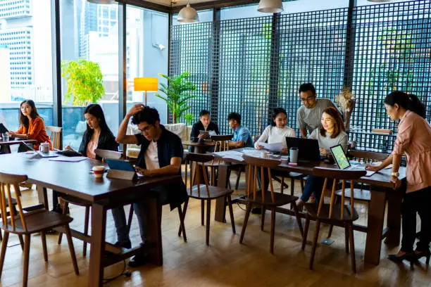 Photo of Asians Millennials busy working in coworking space.