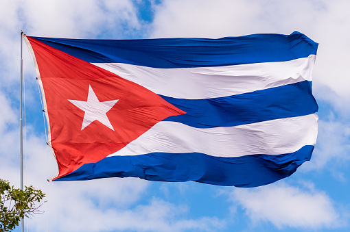 Flag of Cuba on pole in the wind.