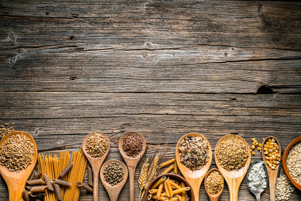 istock Healthy eating: wholegrain cereal and grains border on rustic wooden table 1216800500