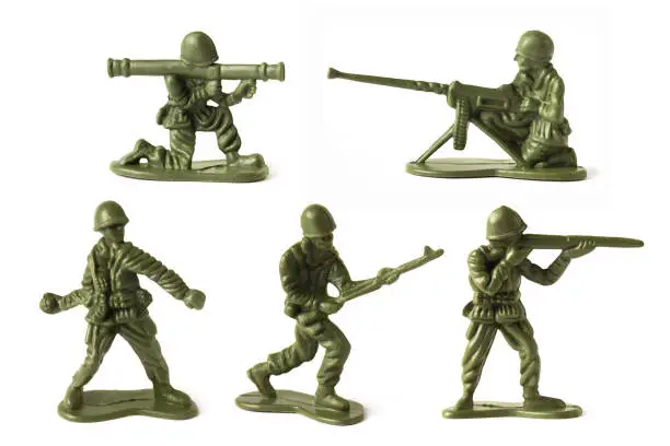 Photo of Collection of green toy plastic soldiers on white