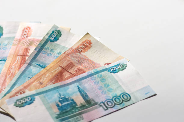istock Russian banknotes on a white background in bright light with a copy of the space 1216801478