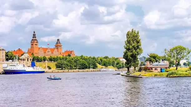 Cruise ship docked on Rampart of Brave embankment of Odra River. West Pomeranian Regional Authority and Passport Office in background, Szczecin