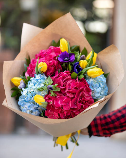 istock Woman holding flower bouquet 1216804487