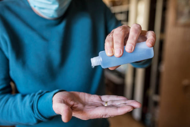 istock Senior man disinfecting hands with hand sanitizer 1216804501