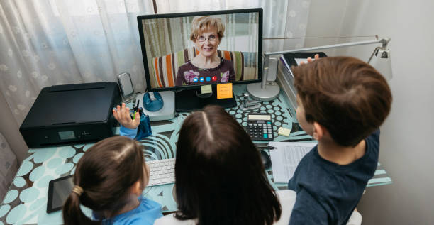 Family talking on video call with grandmother Top view of mother and children talking on video call with computer with grandmother stay at home saying stock pictures, royalty-free photos & images
