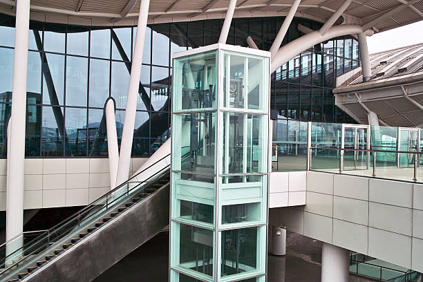 Glass elevator and escalator stock photo
