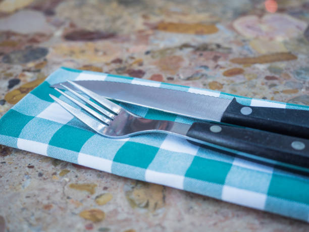 istock Fork and knife on a napkin. close-up 1216807062
