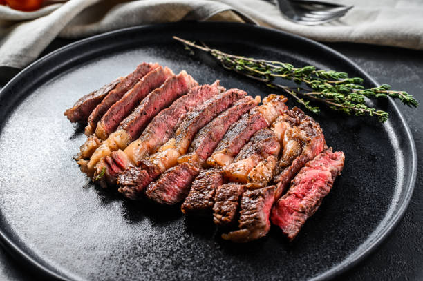 istock Grilled sliced Steak Rib eye with Pepper. black background. top view 1216807913