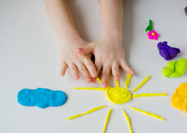 istock Child hands playing with colorful clay. Homemade plastiline 1216807921