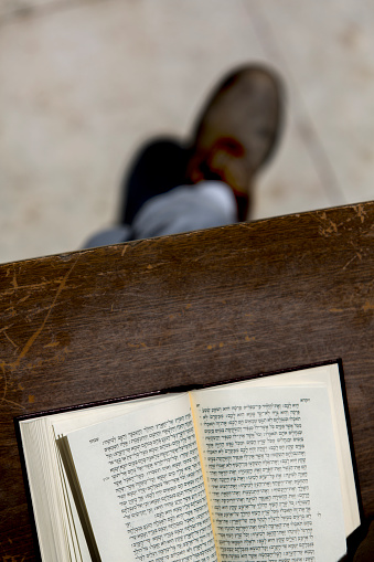 Jew reading prayer book. praying from hebrew Bible at Wailing Wall in Jerusalem, Israel