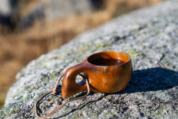 istock Wodden cup with coffee on a stone outdoors 1216809503
