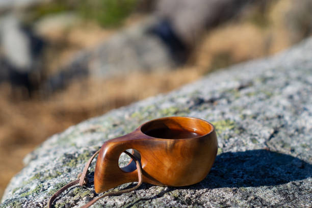 istock Wodden cup with coffee on a stone outdoors 1216809504