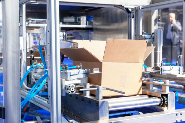 istock Automatic cardboard package box packaging machine in the factory 1216810642