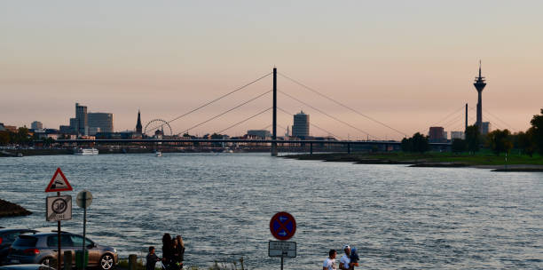 Duesseldorf, Germany October 15, 2017: unidentified people walk along the Rhine promenade in Duesseldorf, in the background the Rheinturm