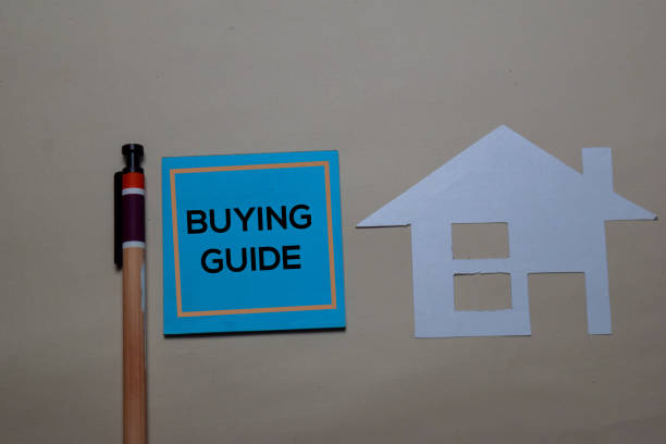 istock Buying Guide write on a sticky note and home made with paper isolated on office desk. 1216810985