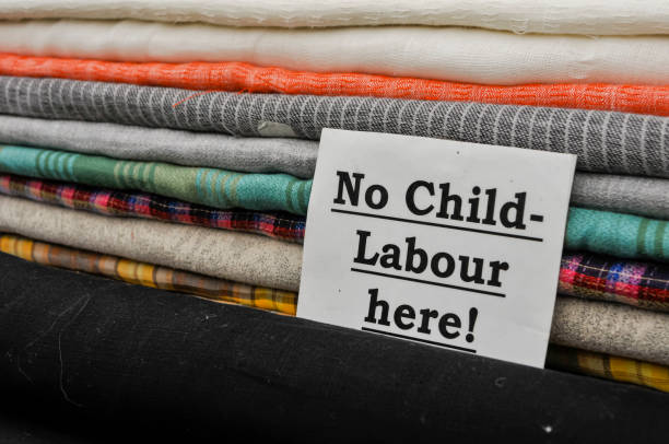 Sign at a cloth shop advising customers the no child labour is used in the production of their goods. Sign at a cloth shop advising customers the no child labour is used in the production of their goods. child labor stock pictures, royalty-free photos & images