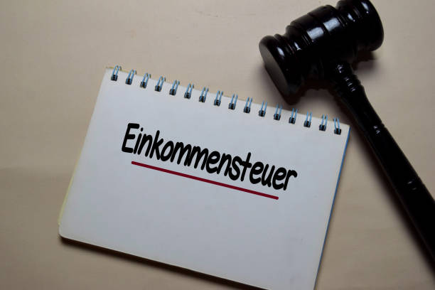 istock Einkommensteuer write on a paperwork with gavel isolated on Office Desk. German Language it means Income Tax 1216811620
