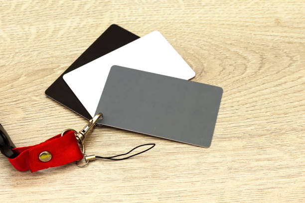 istock Grey card with a red strap, a photographer’s tool, determining the correct white balance 1216812051