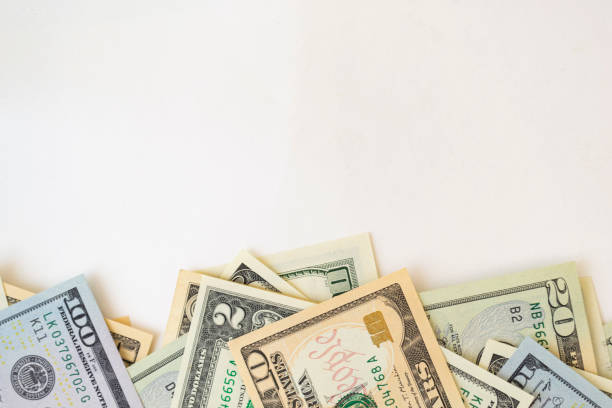 istock Side frame of different dollar cuperas randomly lie on a white background. Concept business, monetary fund. 1216812098