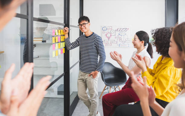 istock Asian business people clapping hands/applause  while meeting for success in modern office, casual clothing 1216812236
