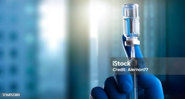 A Medical Hand In A Glove Holds An Ampoule With A Vaccine And A Syringe With Illustration Stock Photo - Download Image Now